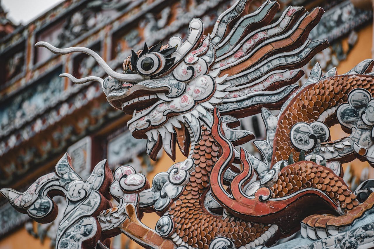 gallery-1 Close-up of a detailed dragon sculpture in a traditional Chinese temple setting.